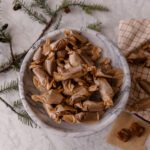 Soft caramels wrapped into parchment in a bowl on a marble countertop