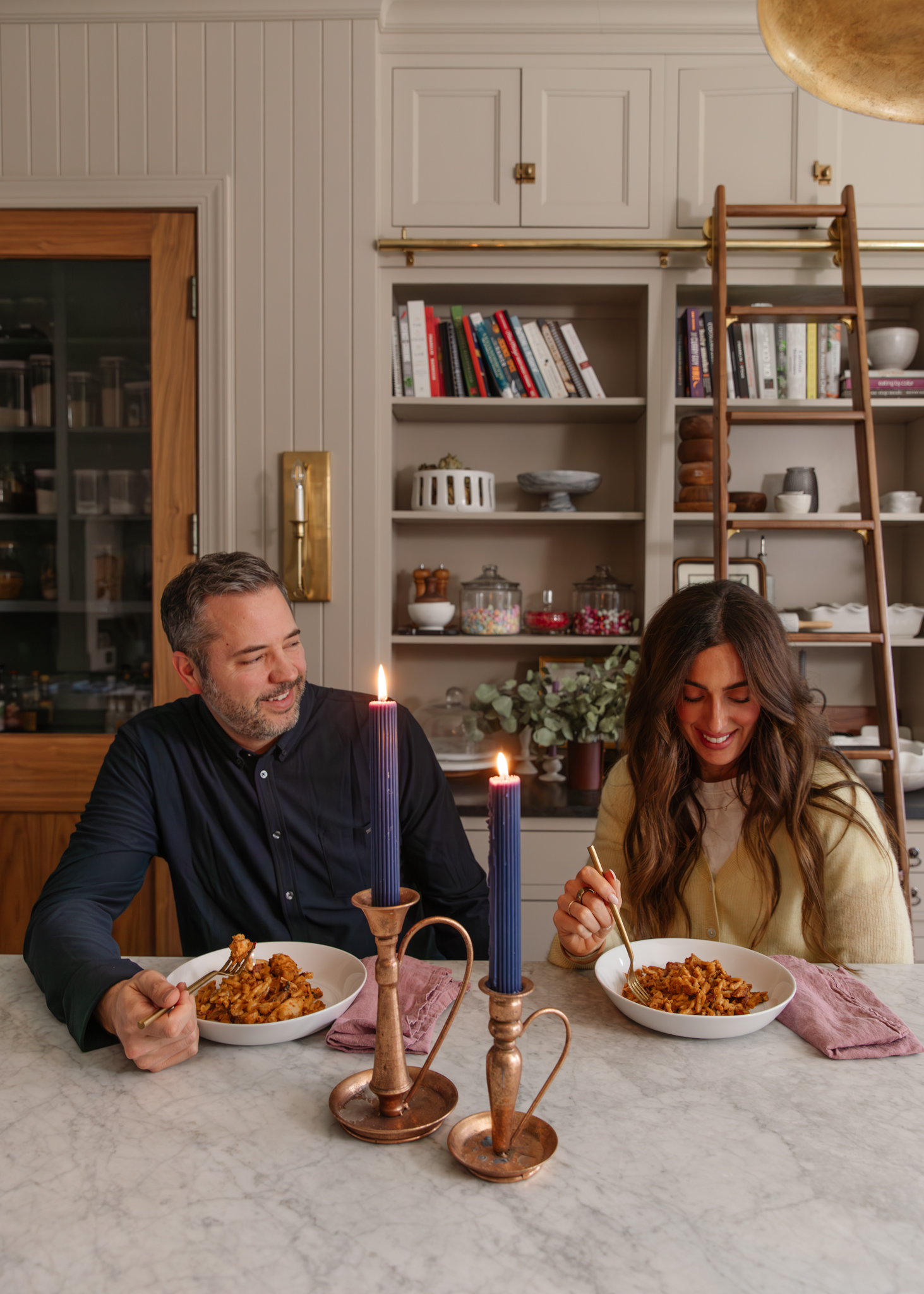 Chris and Julia eating a romantic dinner at the kitchen island