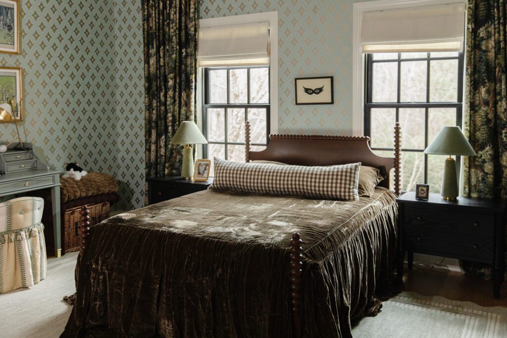 Dark green velvet bedspread on a turned wood bed in a girl's bedroom