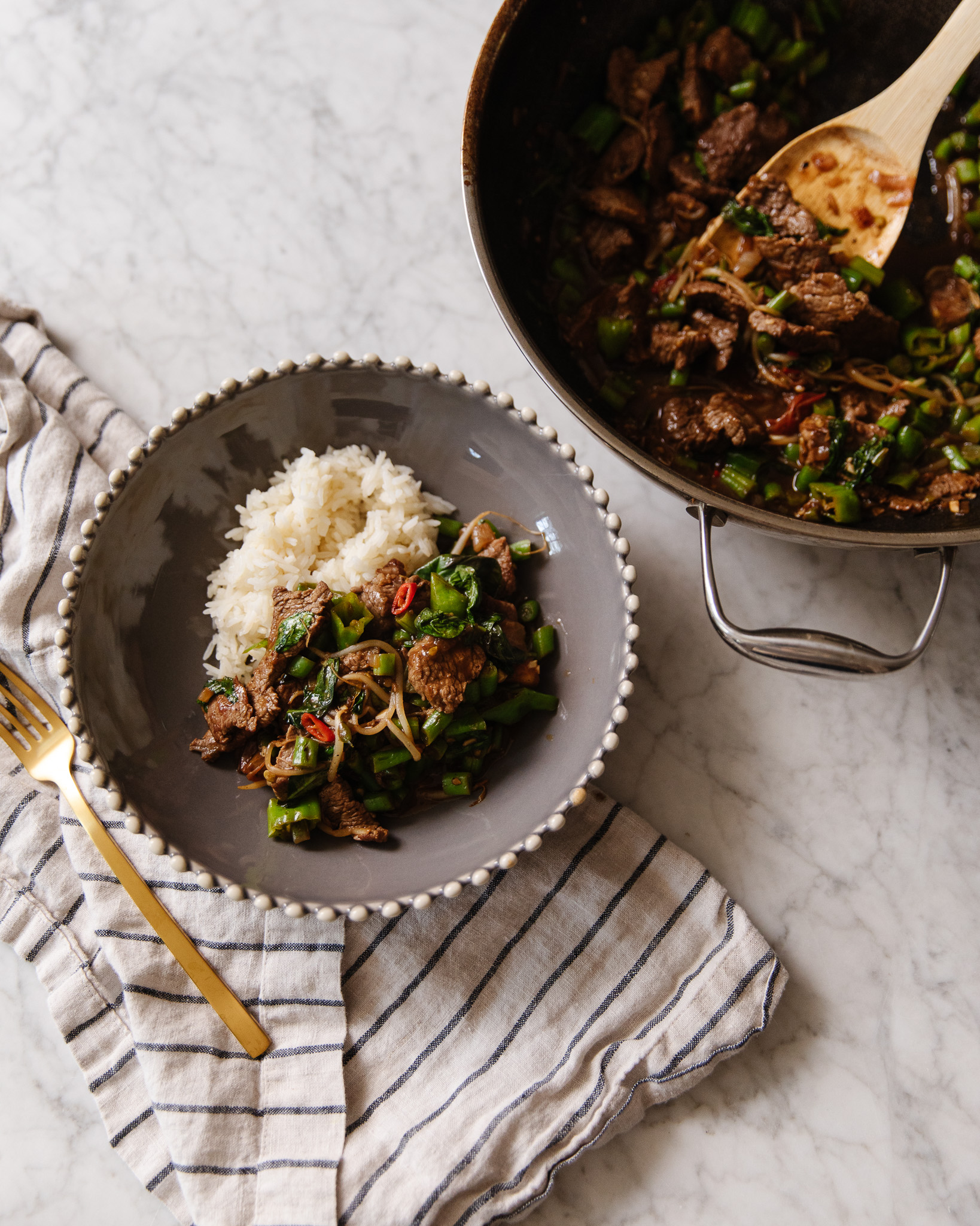 A bowl of Thai-Inspired Basil Beef Stir-Fry with jasmine rice