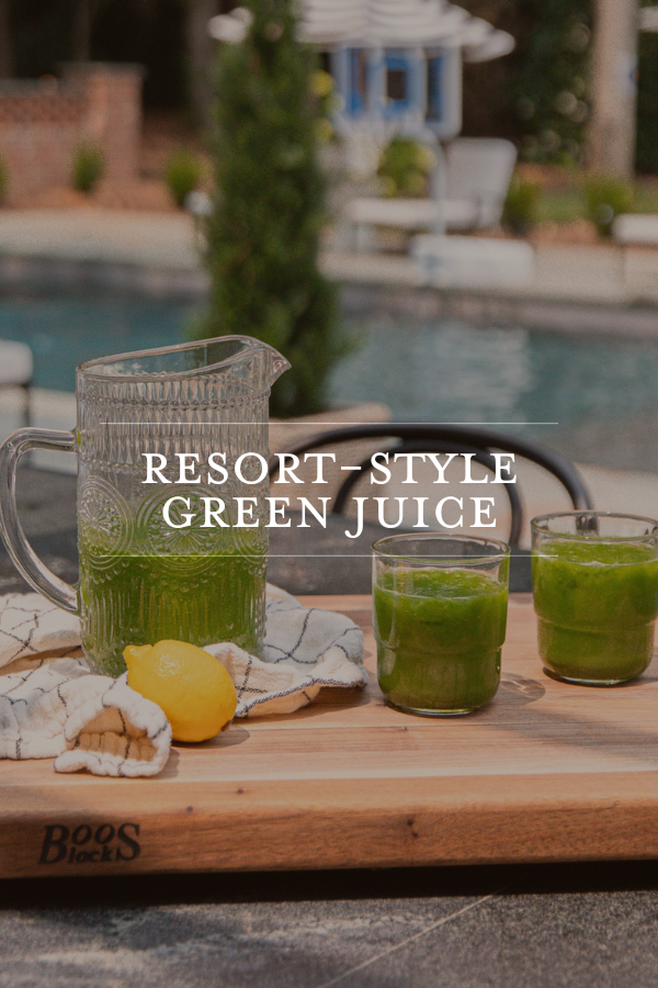 Green juice in a glass pitcher on an outdoor table