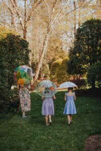 Girls in dresses holding cute clear umbrellas