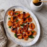 A serving platter of caramelized apricots over a whipped ricotta cream