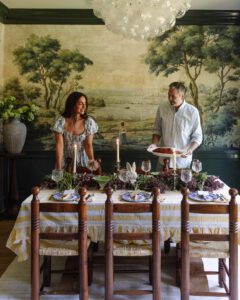 Chris & Julia putting a ham on a table set for Easter dinner