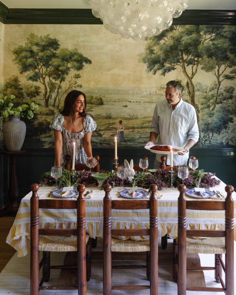 Chris & Julia putting a ham on a table set for Easter dinner