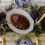 Apricot-glazed ham on a serving platter on an Easter table