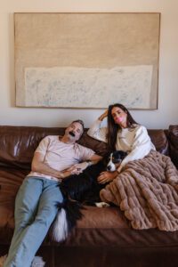 Chris & Julia on the couch wearing their favorite brands of mouth tape