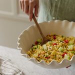 Chris stirring a bowl of grilled corn salad