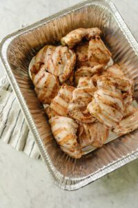 A foil tin filled with salt & vinegar chicken