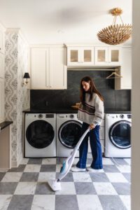 Julia with a steam mop in her laundry room