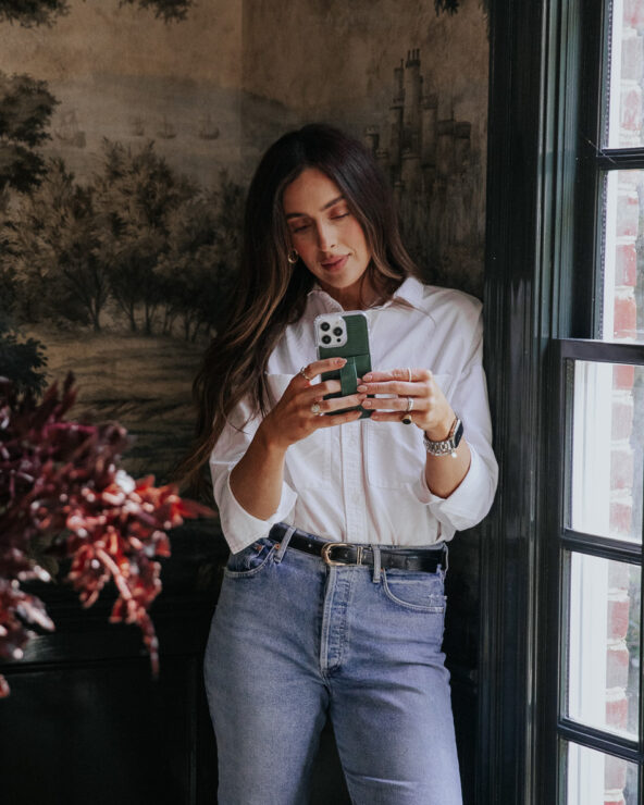 Julia holding a smart phone with a luxury phone case