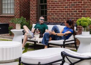 Chris & Julia and Cricket on the outdoor sofa.