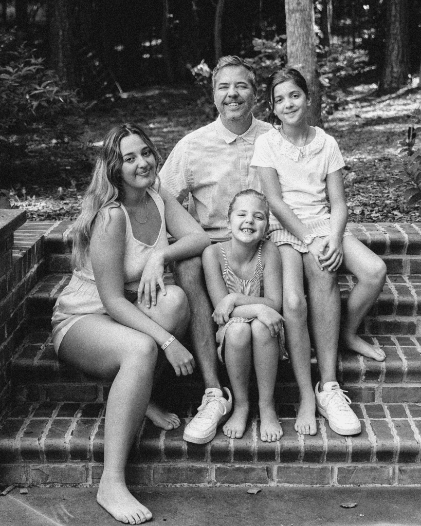 Chris & his three daughters in black & white