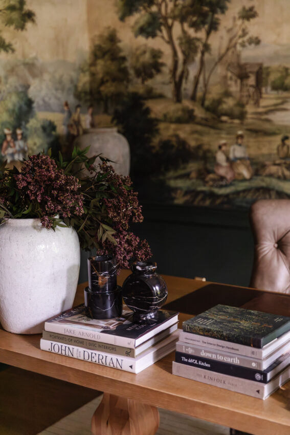 Study desk with coffee table books and dark marble vases