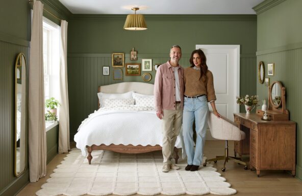 Chris & Julia in front of a Pottery Barn bed and dresser