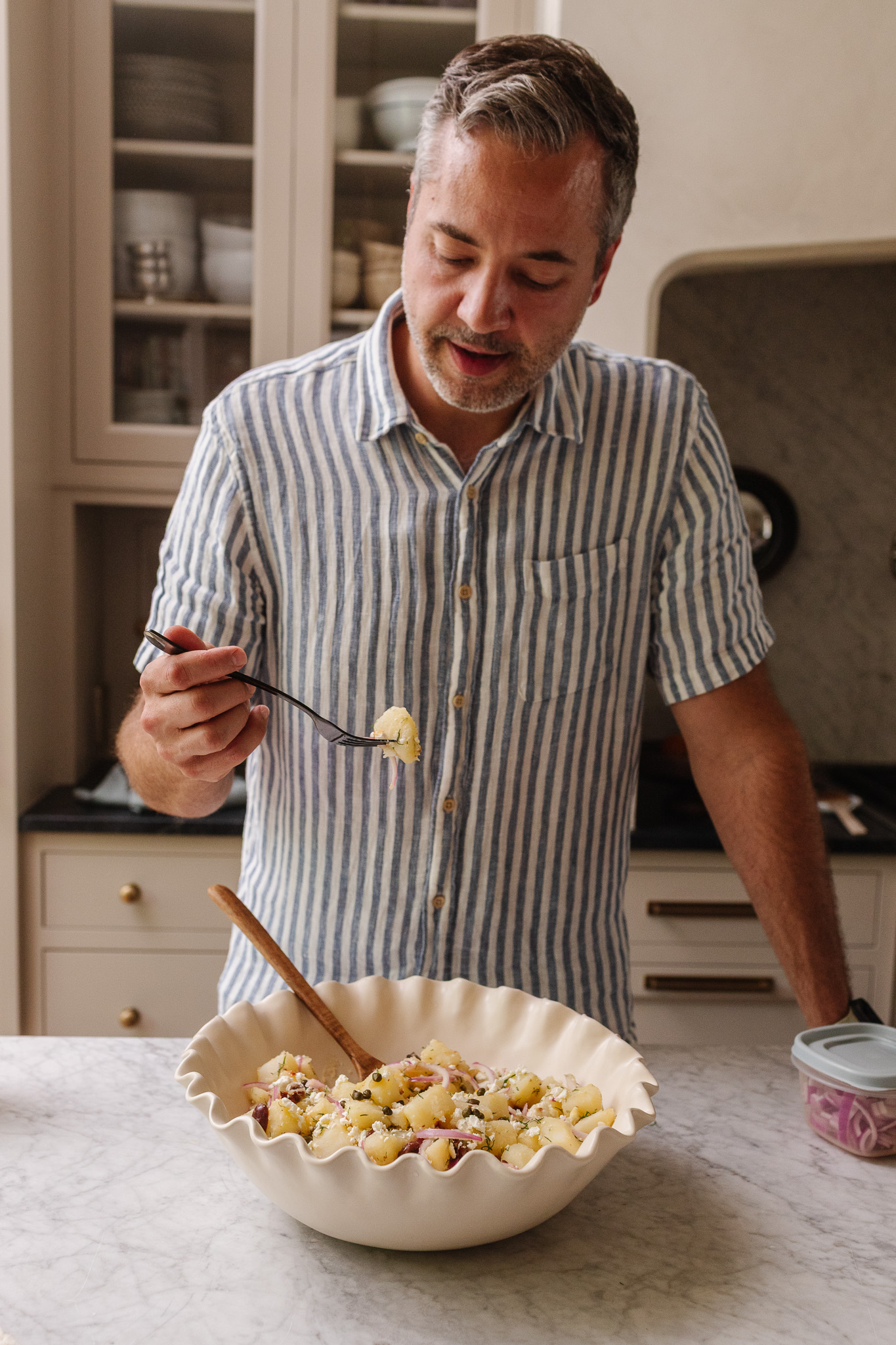 Chris tasting the Greek Potato Salad with a fork