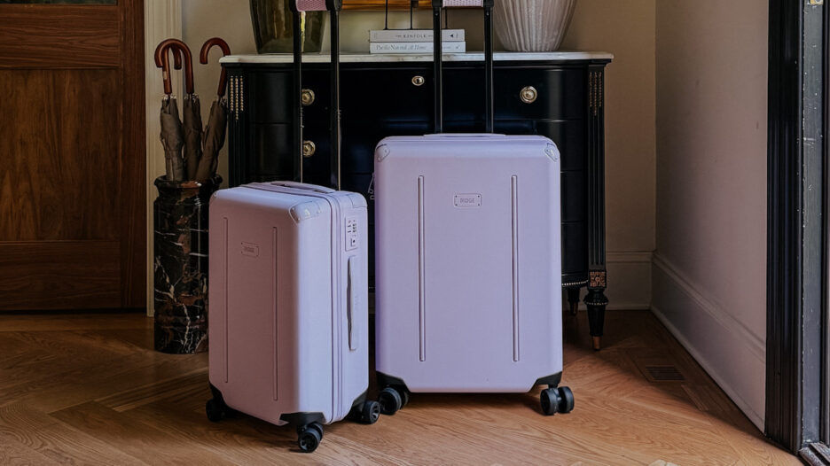 A photo of purple Ridge suitcases in the entryway of a moody, modern, traditional home
