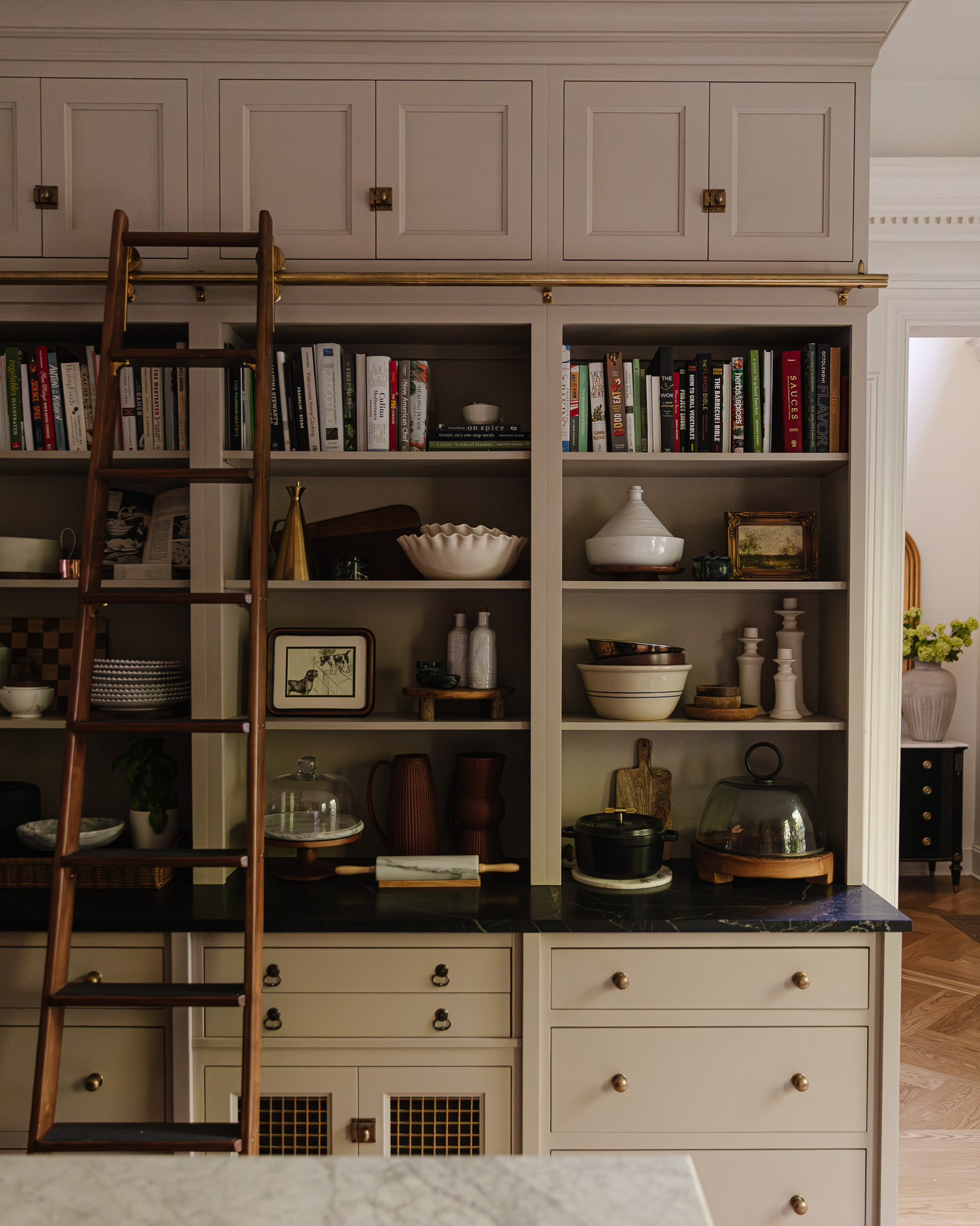 Open shelves in a kitchen displaying cookbooks and functional kitchen decor