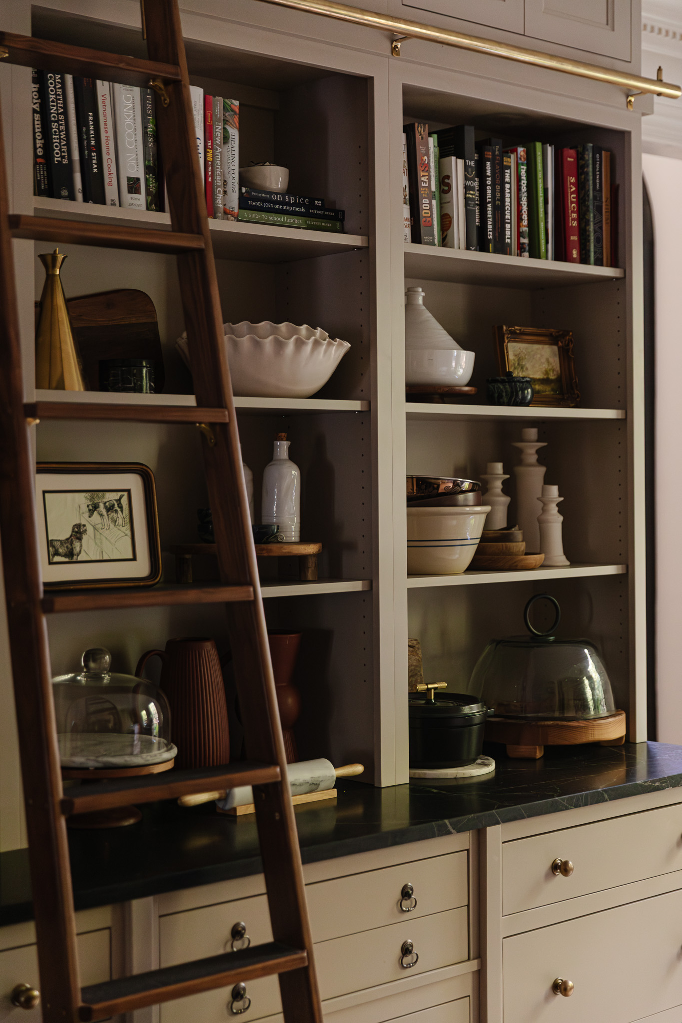Kitchen shelves styled with mixing bowls, salt crocks, cake plates