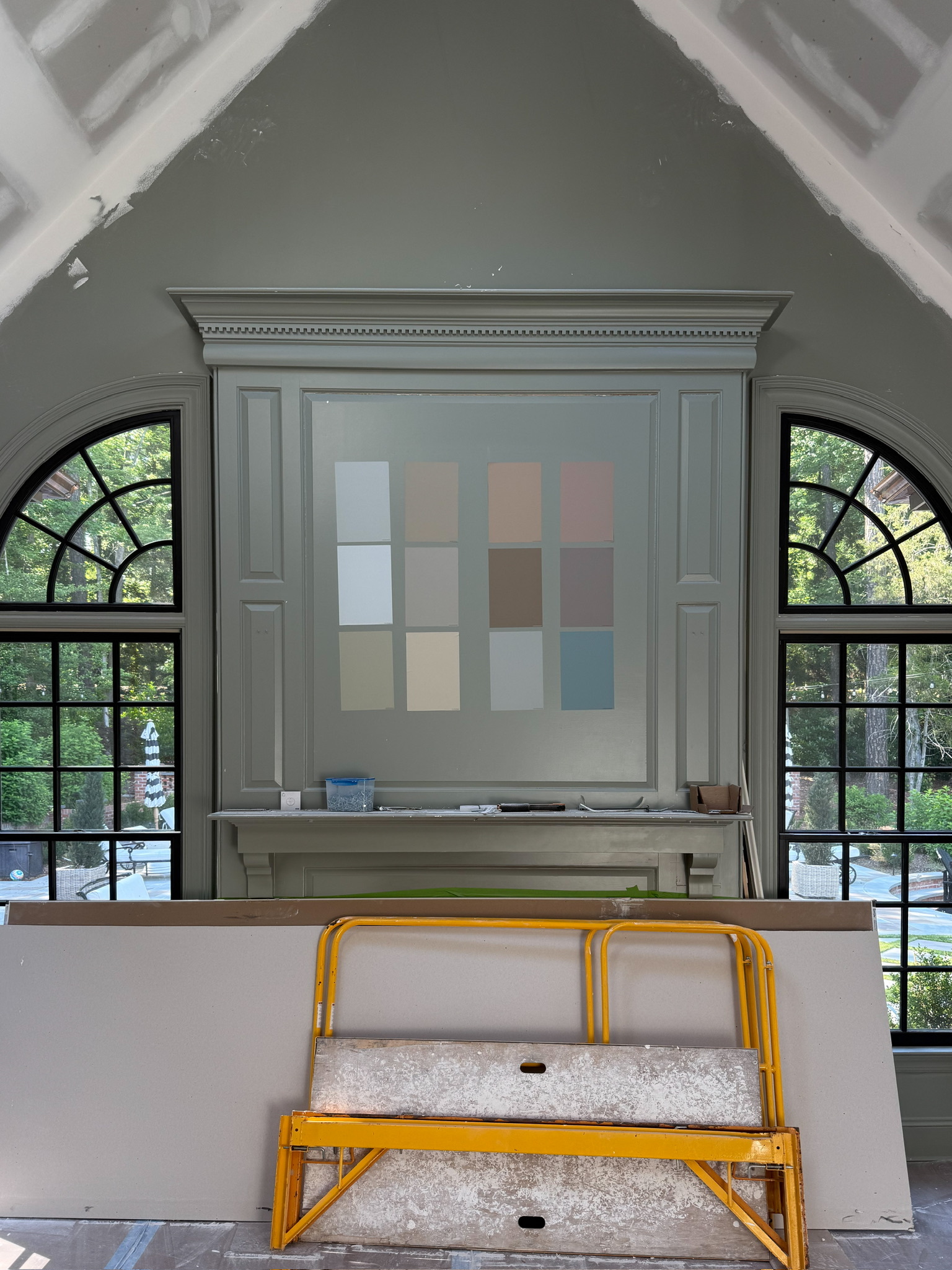 Samples of Farrow & Ball paint colors on the living room mantle