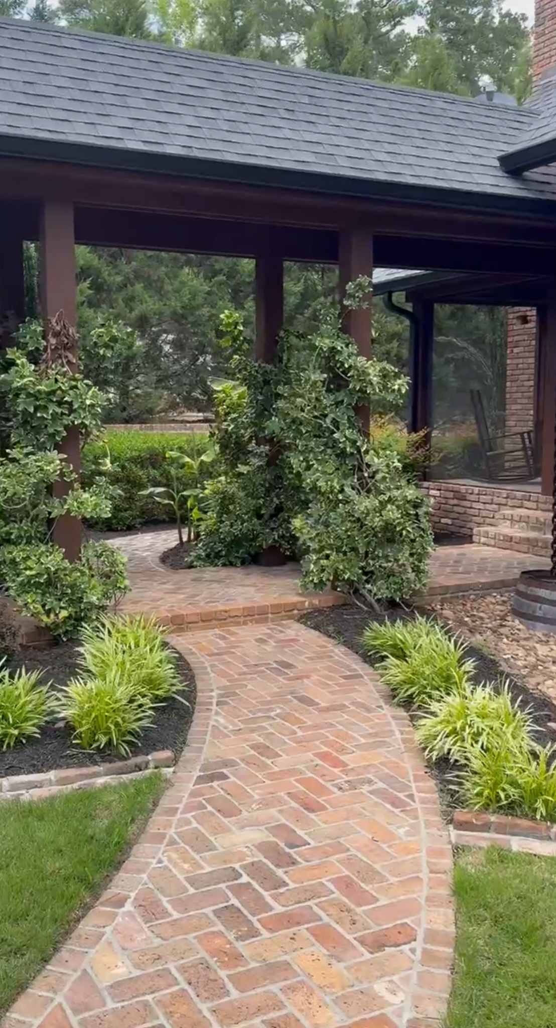 Well-manicured patio and pathway behind a lake house