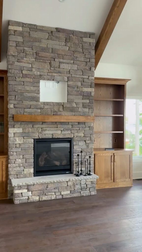 Rock wall with a fireplace in a lake house living room