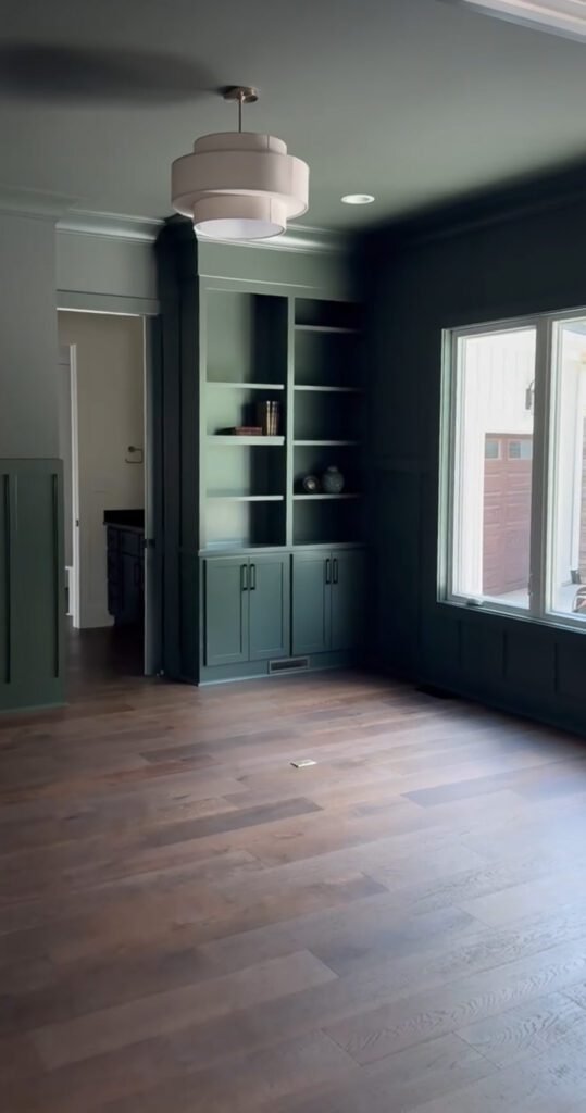 A moody green room with built-ins