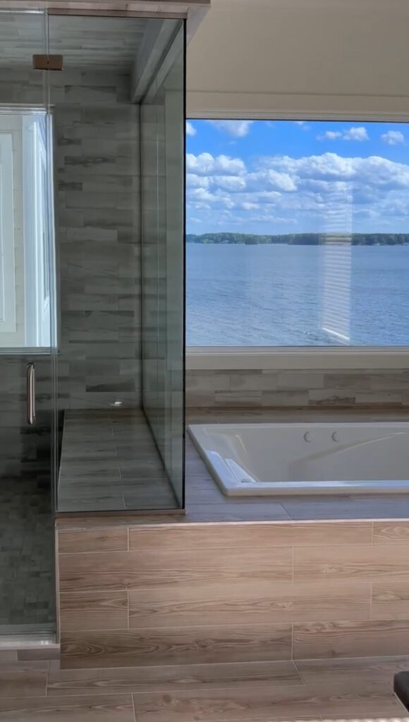 A bathtub with a view of a lake