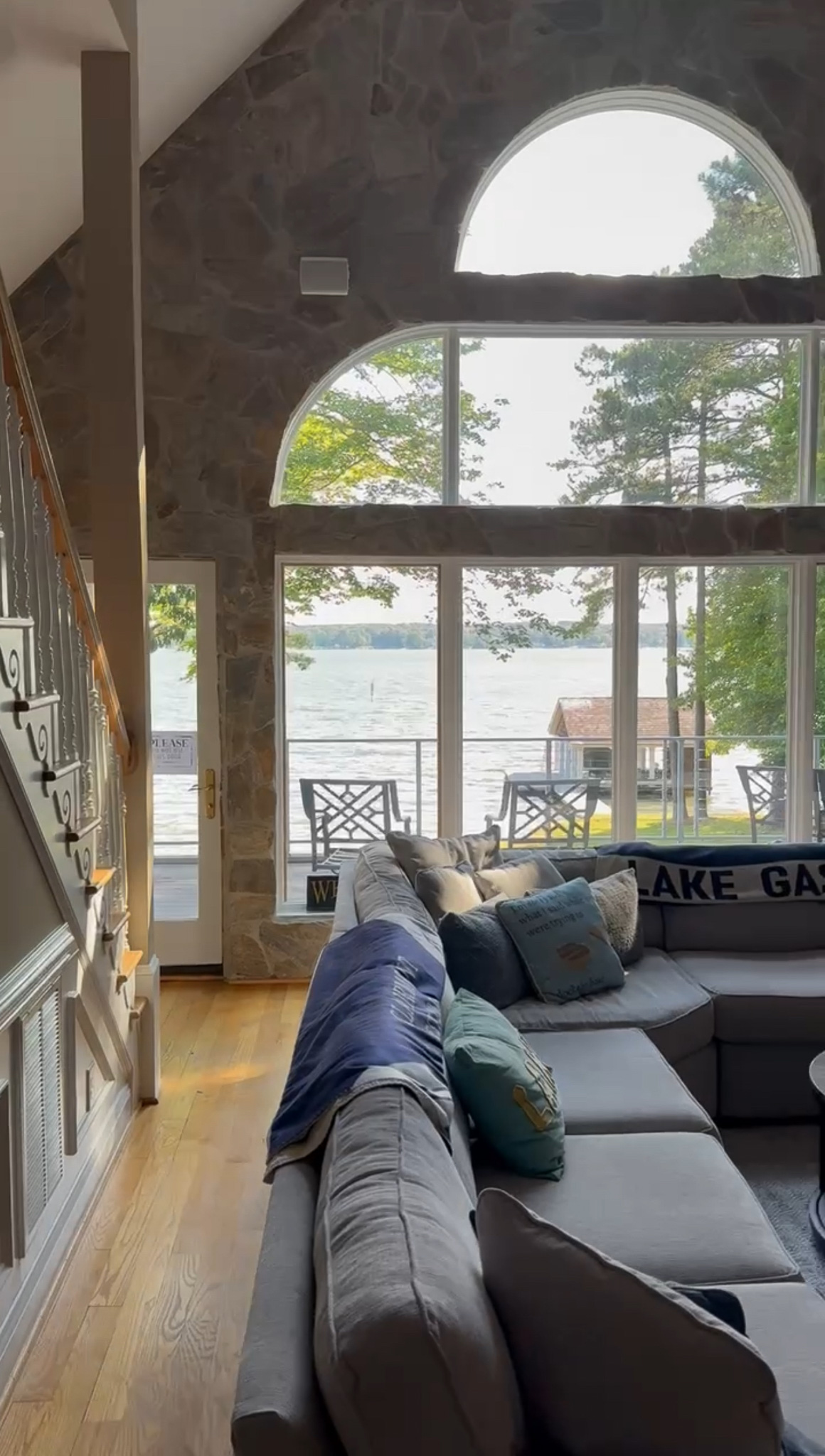 Cozy lake house living room with big windows and wraparound couch
