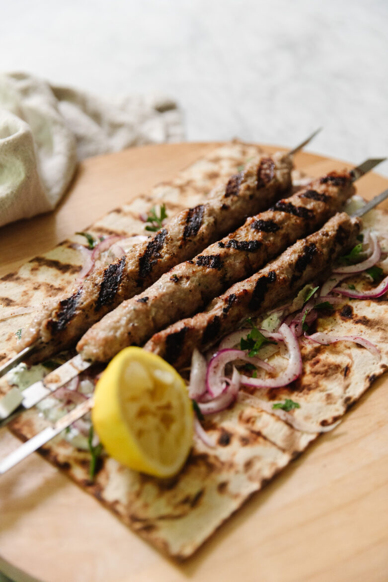 Grilled ground pork kebabs on flatbread
