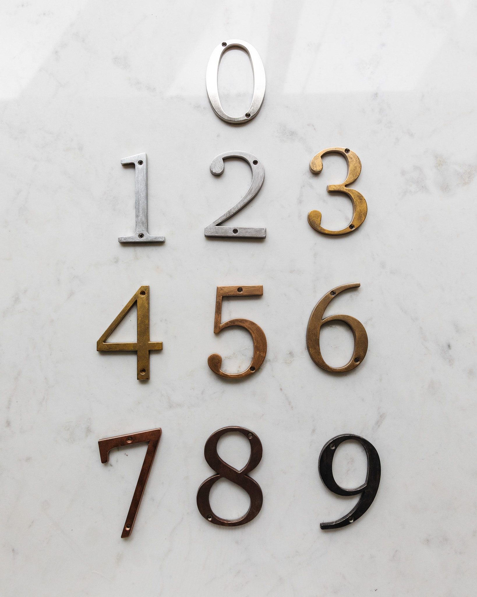 Comparison of all 9 Rub 'n Buff colors on silver metal house numbers