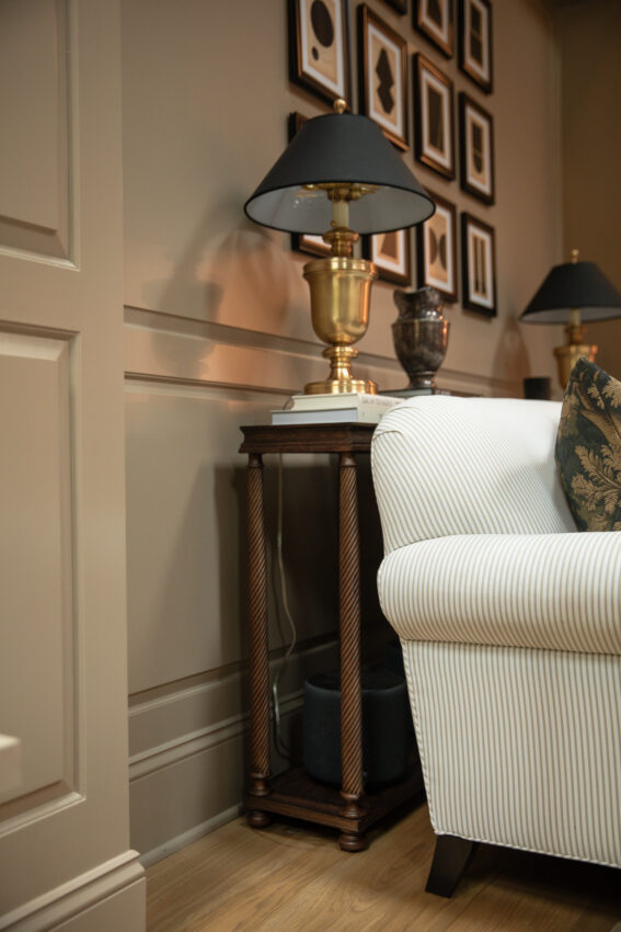 A turned wood console table behind a sofa in a living room.