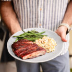 Chris holding a platter of ribs