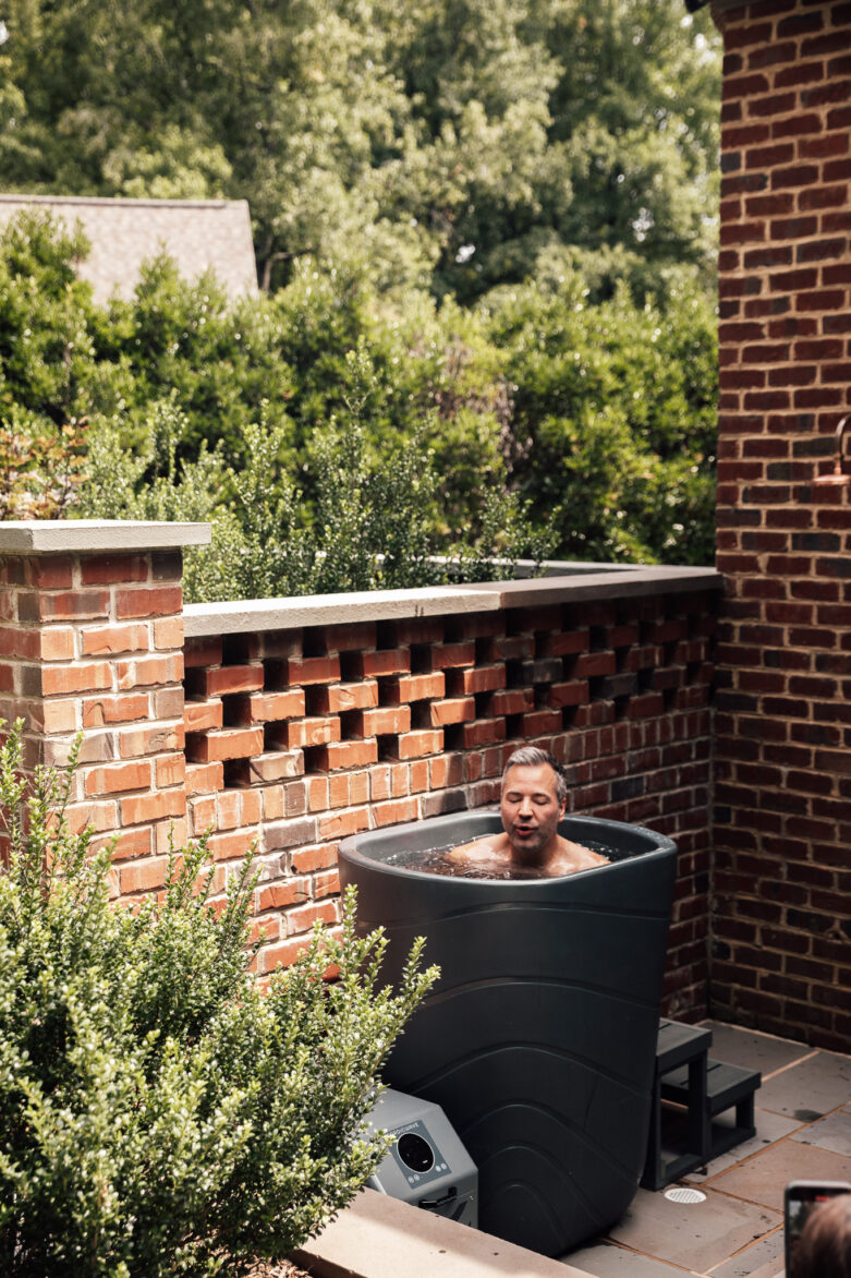 Chris dipping into a cold plunge