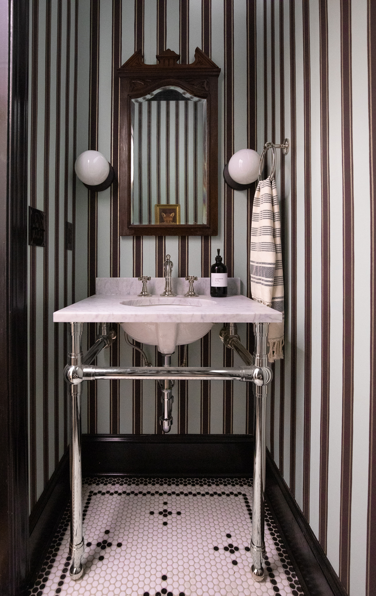 Powder bathroom before with striped wallpaper