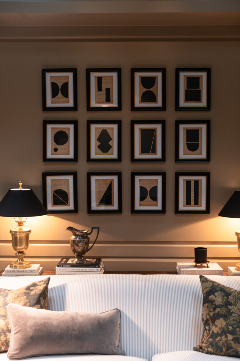 A composed grid of 12 black and tan abstract framed pictures on the wall