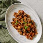 Roasted Sweet Potatoes with Romesco Sauce on an oval plate