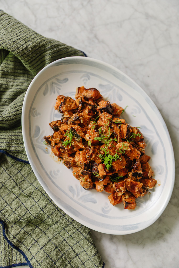 Roasted Sweet Potatoes with Romesco Sauce on an oval plate