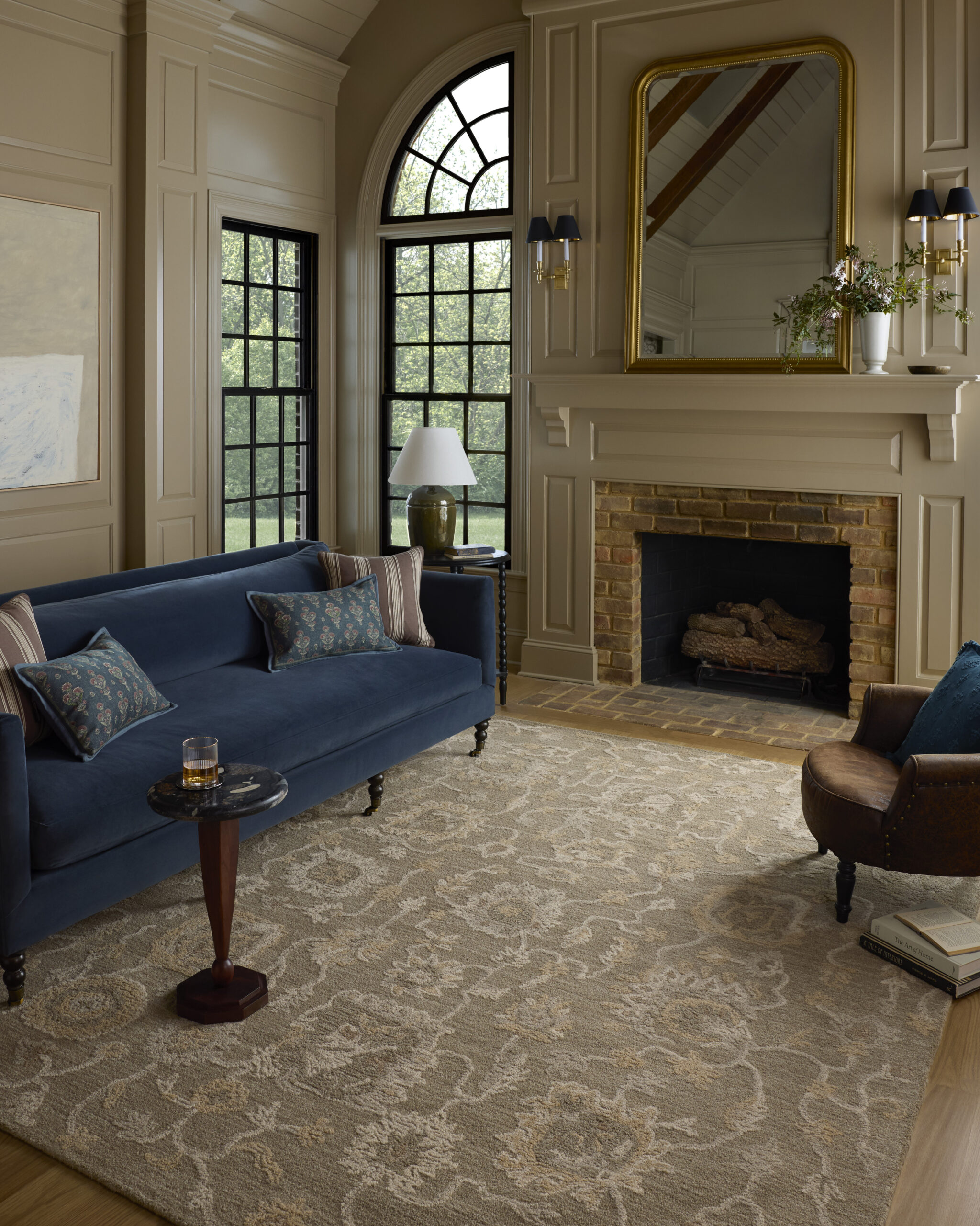 A moody coffee brown living room with the the Dorothea traditional floral pattern rug from Chris Loves Julia x Lololi
