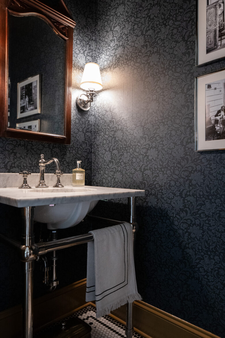 Powder bathroom with Hague navy wallpaper and sconce