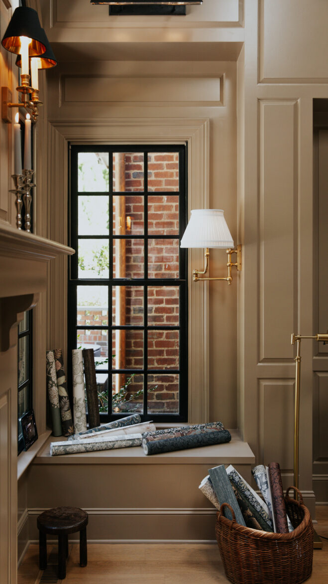 Rolls of moody, modern, traditional non-pasted wallpaper in a basket and on the windowsill