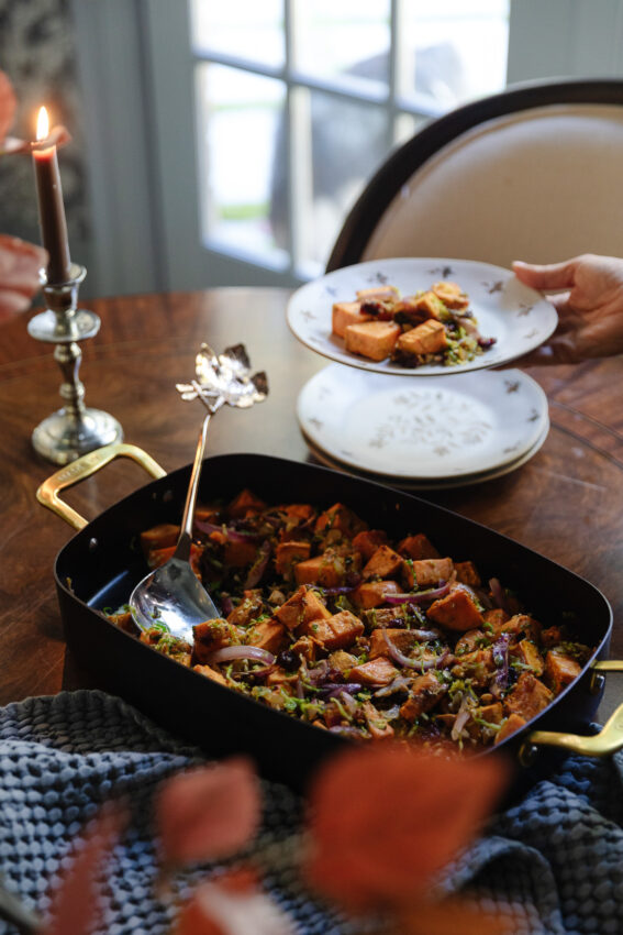 Savory roasted sweet potato casserole served family-style at a cozy dining table, highlighting comfort food and home-cooked meals.