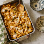 Creamy baked pasta casserole with melted cheese, fresh sage, and perfectly cooked pasta, served in a cozy home kitchen. Ideal for comforting family dinners and easy to make ahead.