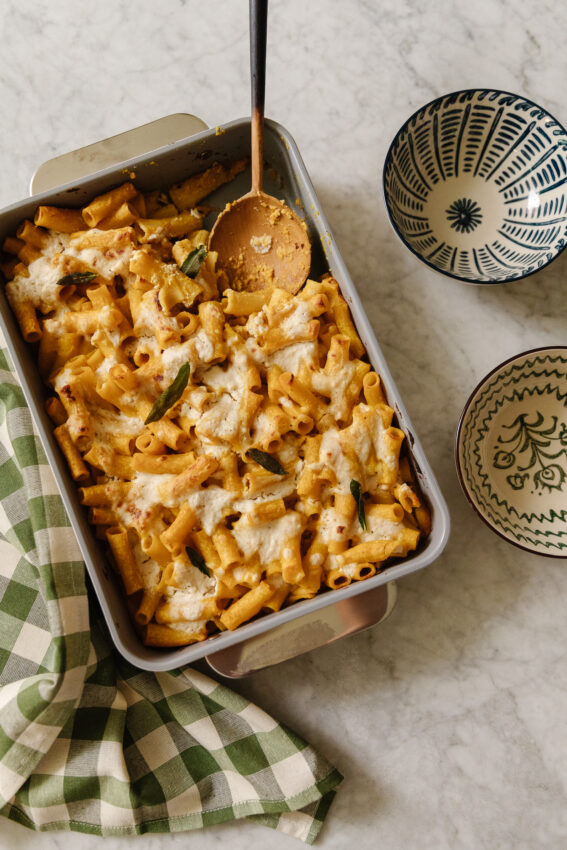 Creamy baked pasta casserole with melted cheese, fresh sage, and perfectly cooked pasta, served in a cozy home kitchen. Ideal for comforting family dinners and easy to make ahead.