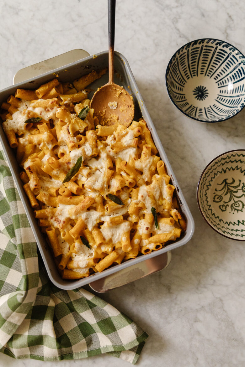 Creamy baked pasta casserole with melted cheese, fresh sage, and perfectly cooked pasta, served in a cozy home kitchen. Ideal for comforting family dinners and easy to make ahead.