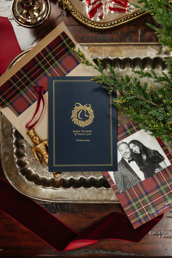Festive holiday greeting card on vintage silver tray with Christmas decor, family photo, and tartan accent; perfect for cozy seasonal home decor.