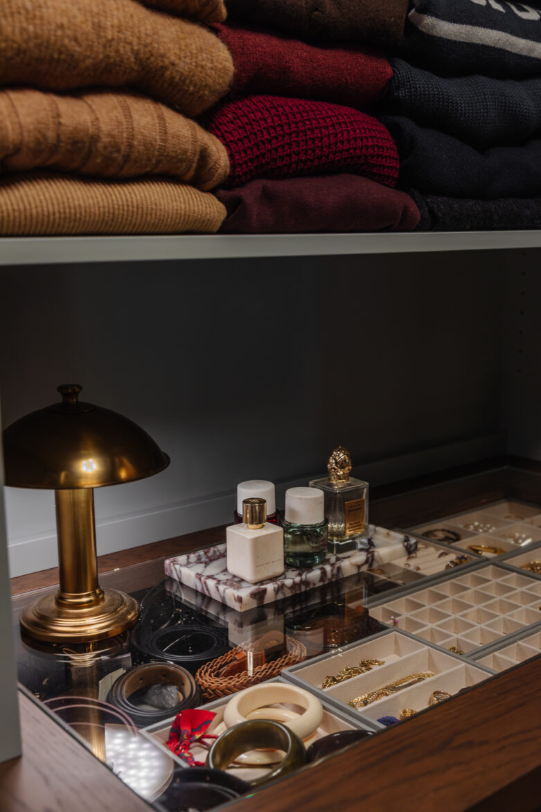 Linen closet organization with folded sweaters and jewelry storage, home decor and personal accessories display, stylish home organization, curated closet design, bedroom closet essentials.