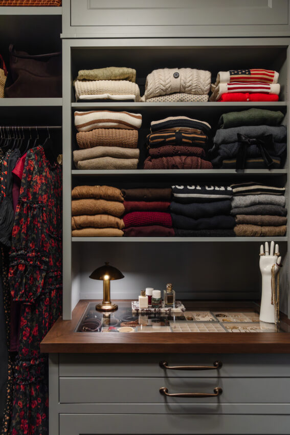 Soft, neatly folded sweaters and accessories organized in a stylish closet.
