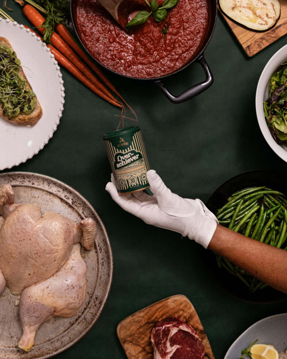 Savory meal ingredients with canned seasoning, fresh vegetables, raw chicken, and beef on a green table, food styling for home cooking recipes