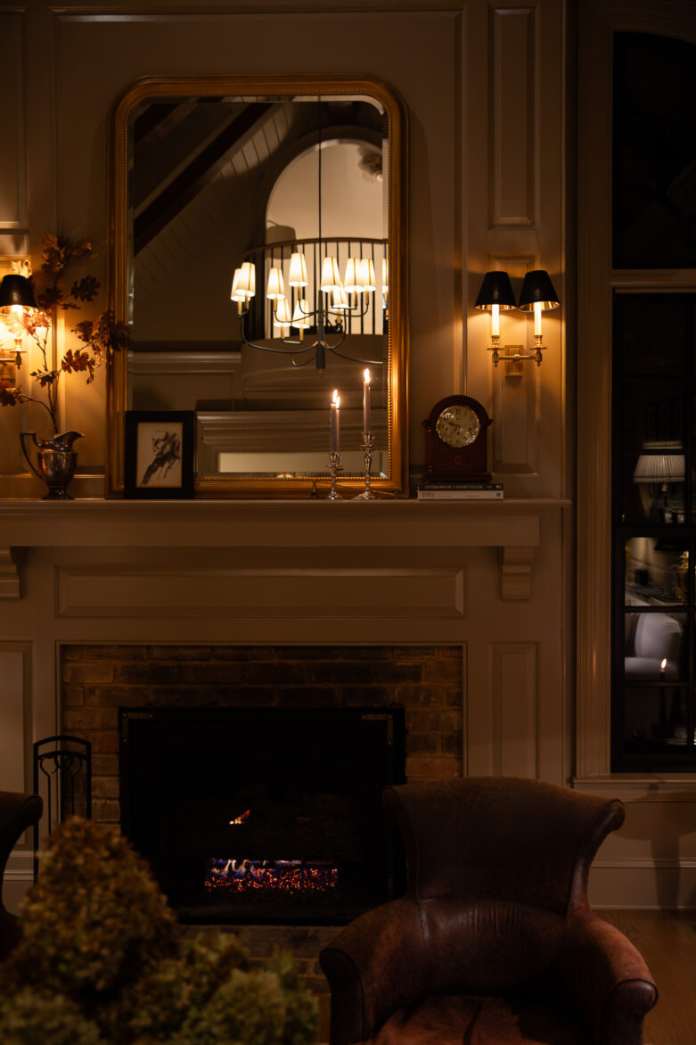 Elegant vintage living room with cozy sofas, warm lighting, and fireplace, showcasing classic interior design and stylish decor.